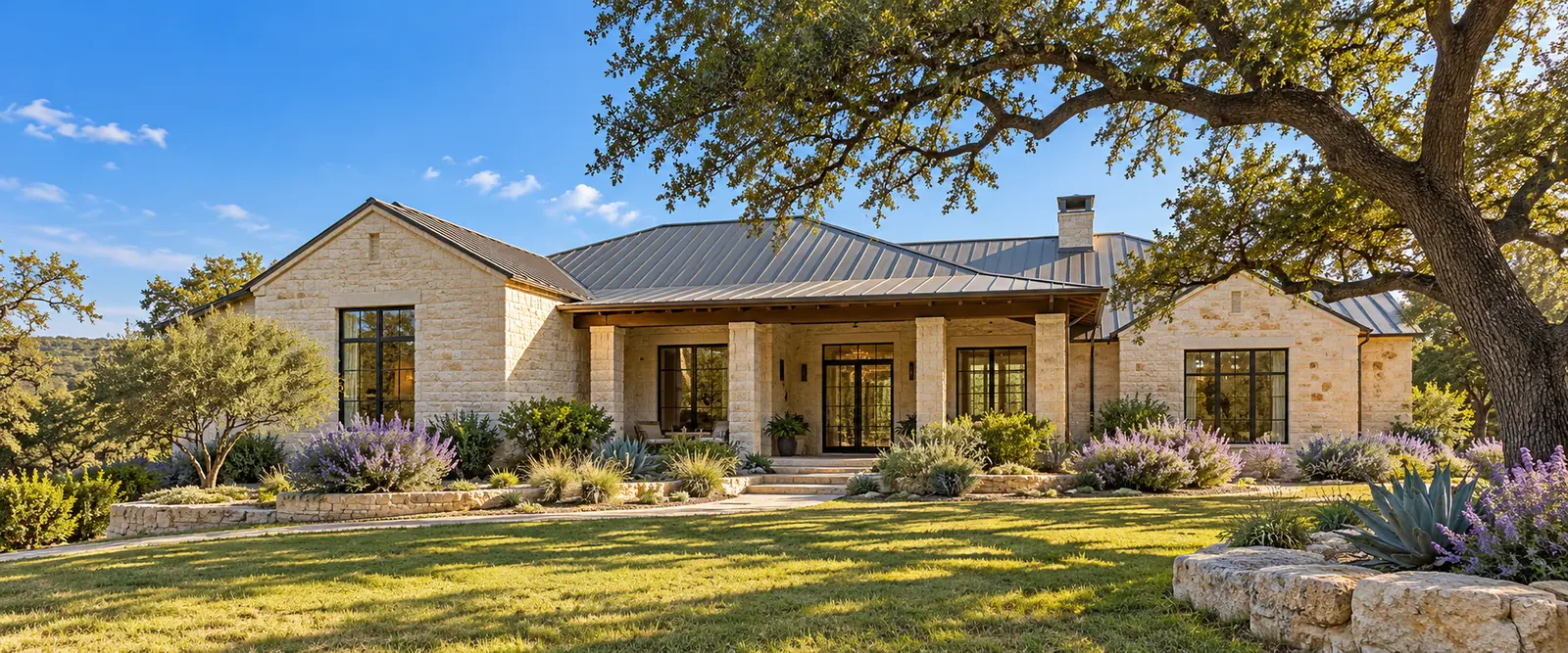 AI-generated San Antonio-style limestone home with a metal roof, live oak, agave and flowering Texas sage AI-generated San Antonio-style limestone home with a metal roof, live oak, agave and flowering Texas sage.